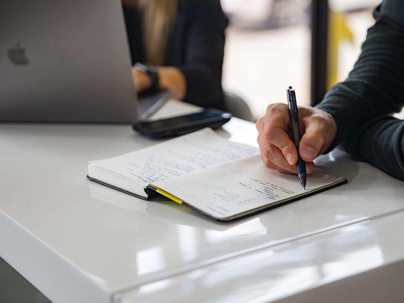 person writing on white paper